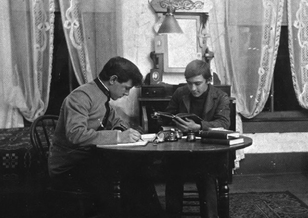 Two Gamma Upsilon brothers studying at the chapter in the early 1900s